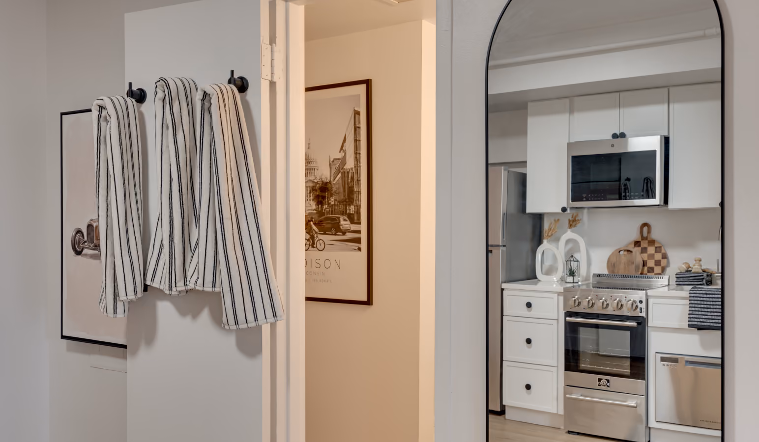 Buckner apartment entry with an arched mirror reflecting the kitchen