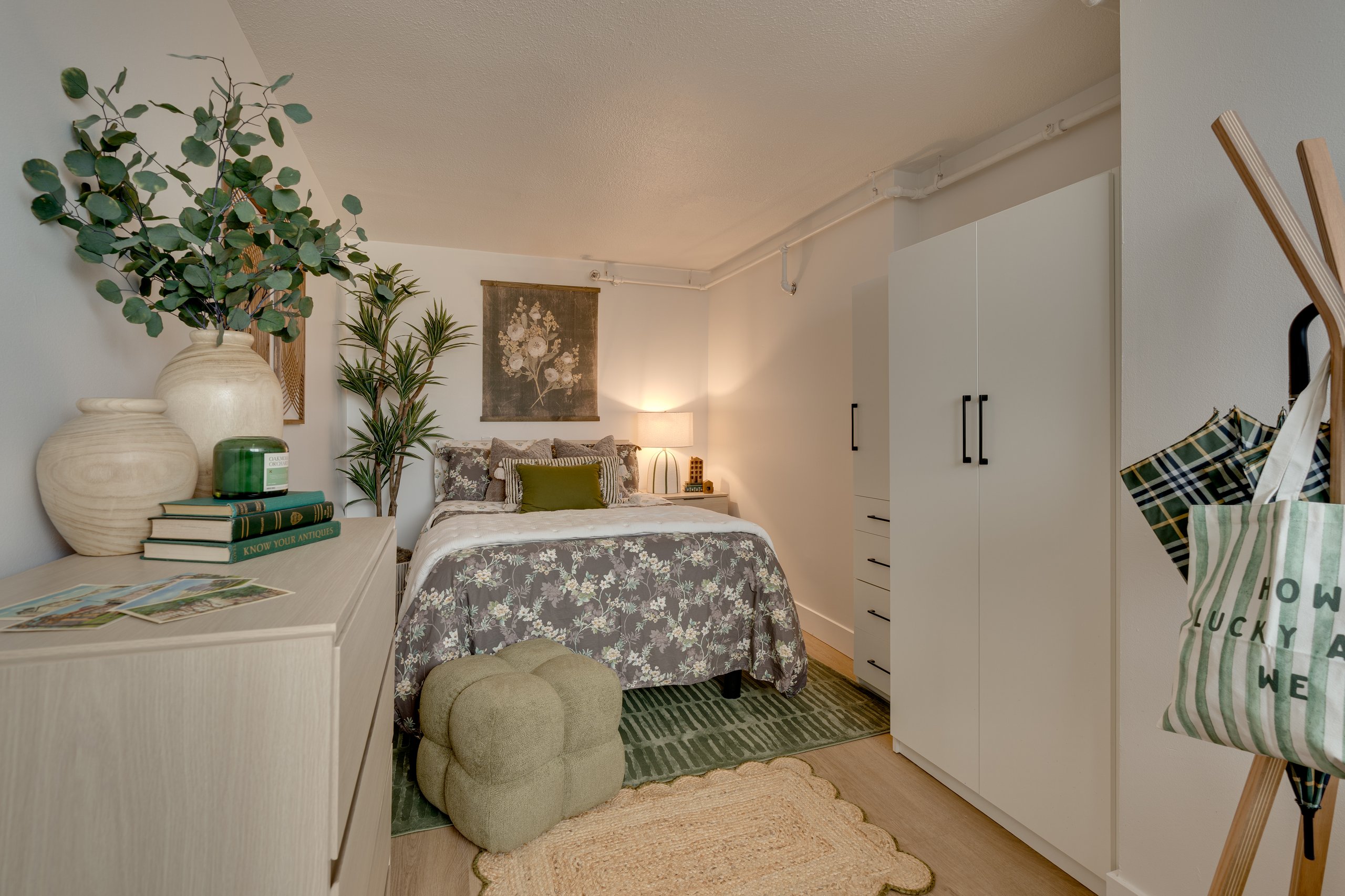 Furnished bedroom with dresser and wardrobe in a Buckner student apartment, Madison, WI