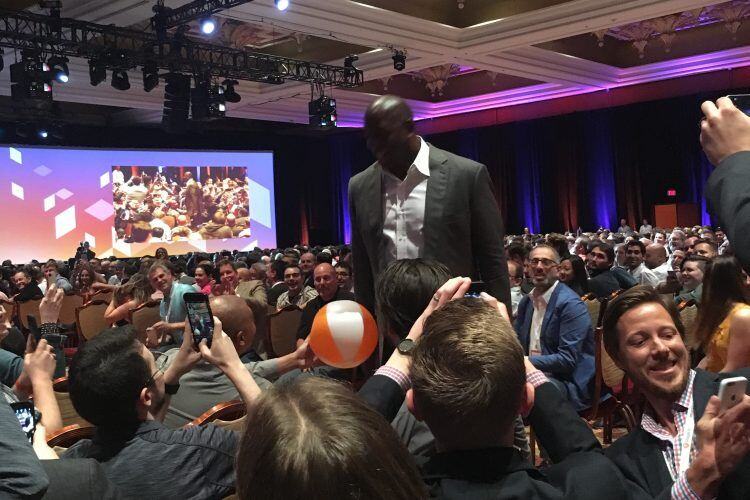 Magic Johnson walking through the seated audience during his Imagine 2016 keynote, with attendees taking photos