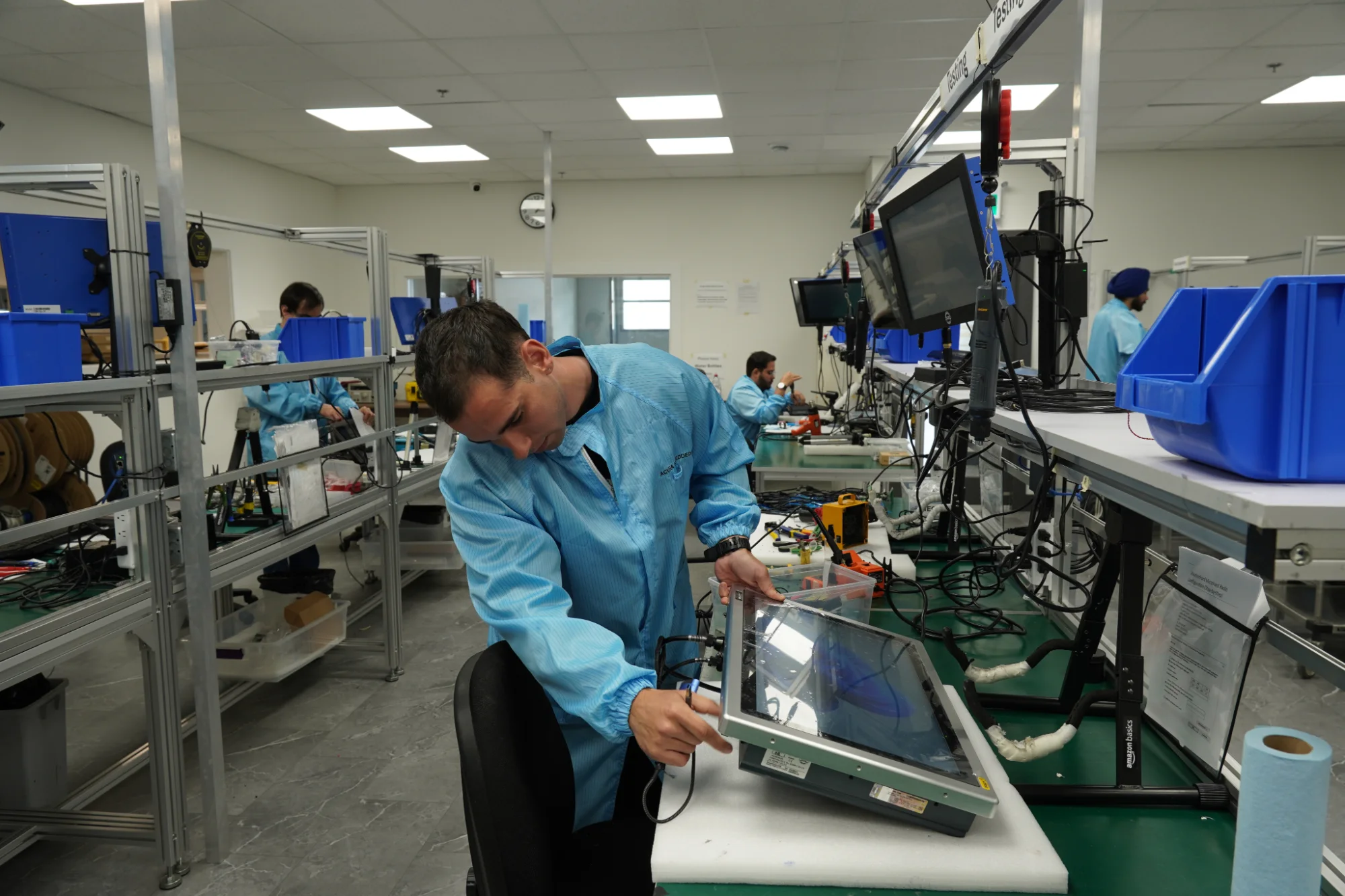 Technician repairing a panel PC on the Acura production floor