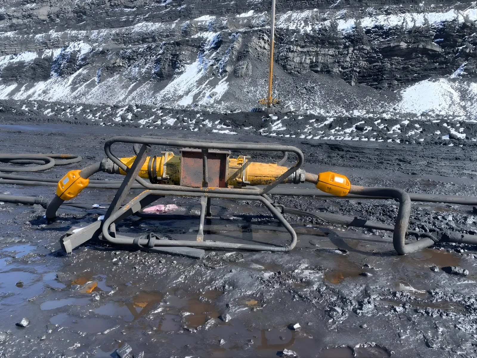 Trailing cable and coupler sled on an open-pit bench, with two AcuSense nodes fitted to the cable