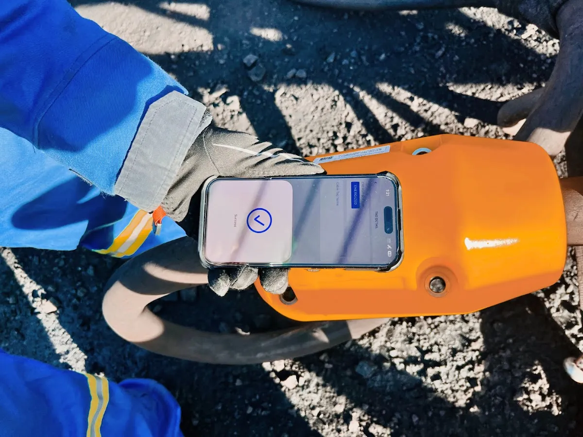Worker tapping a phone on an AcuSense node to read its NFC tag