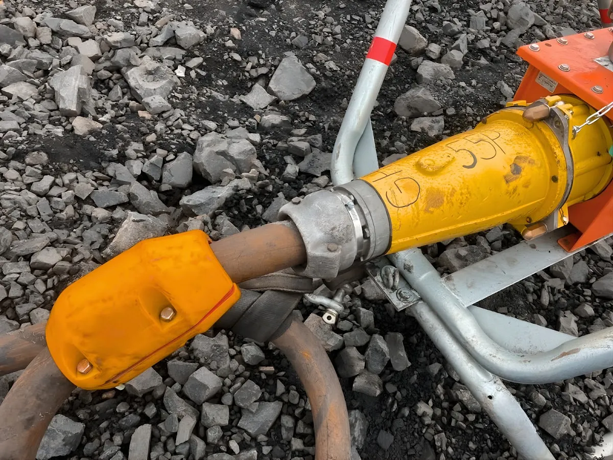 AcuSense node fitted beside a trailing cable coupler on a rocky bench