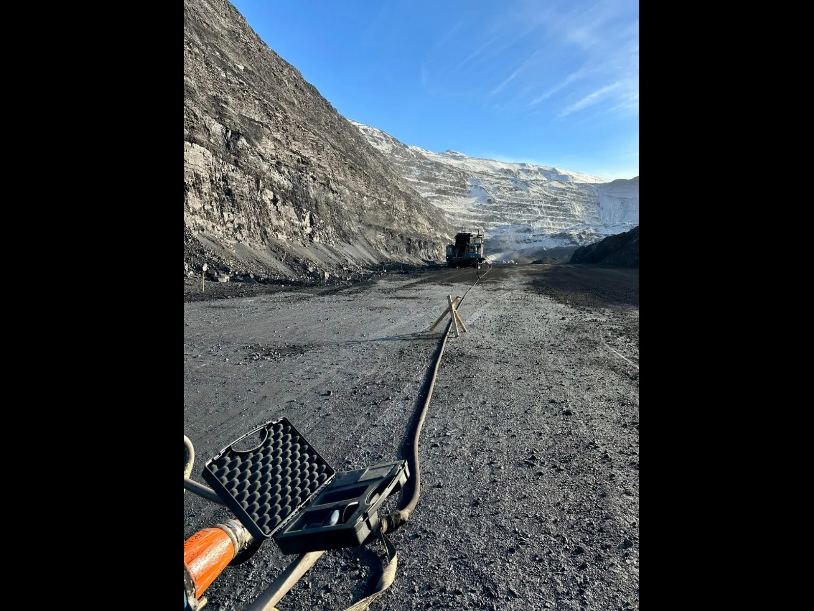 Trailing cable running along a haul road in an open-pit mine