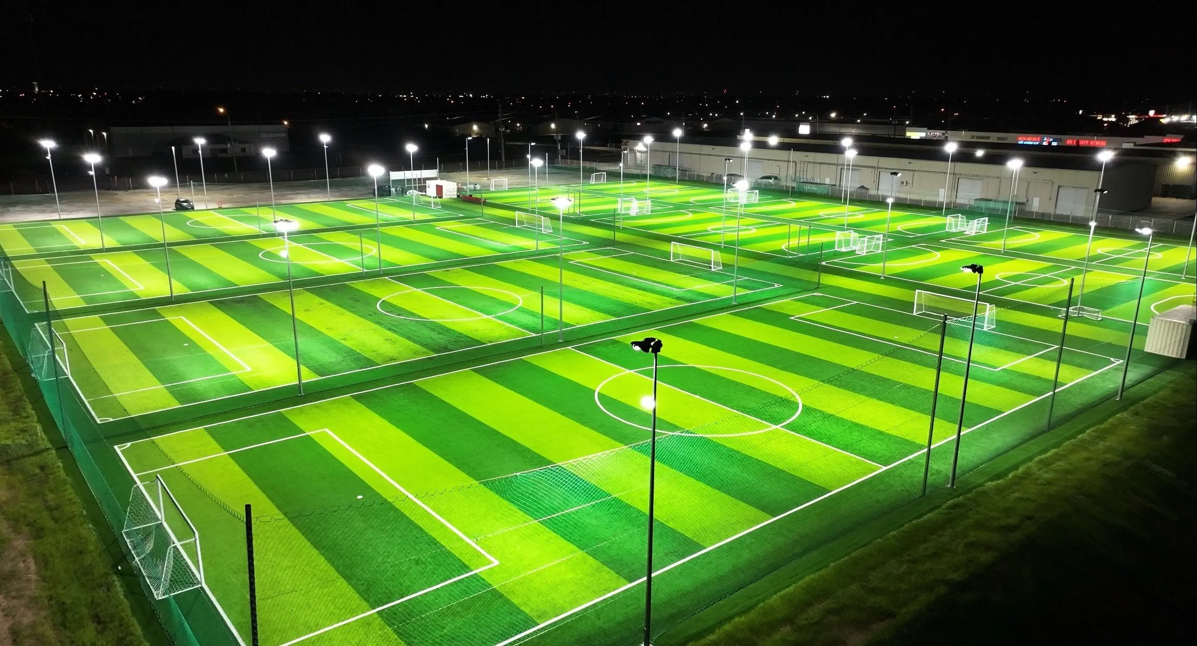 Lit turf soccer fields at night available for field rentals in Austin