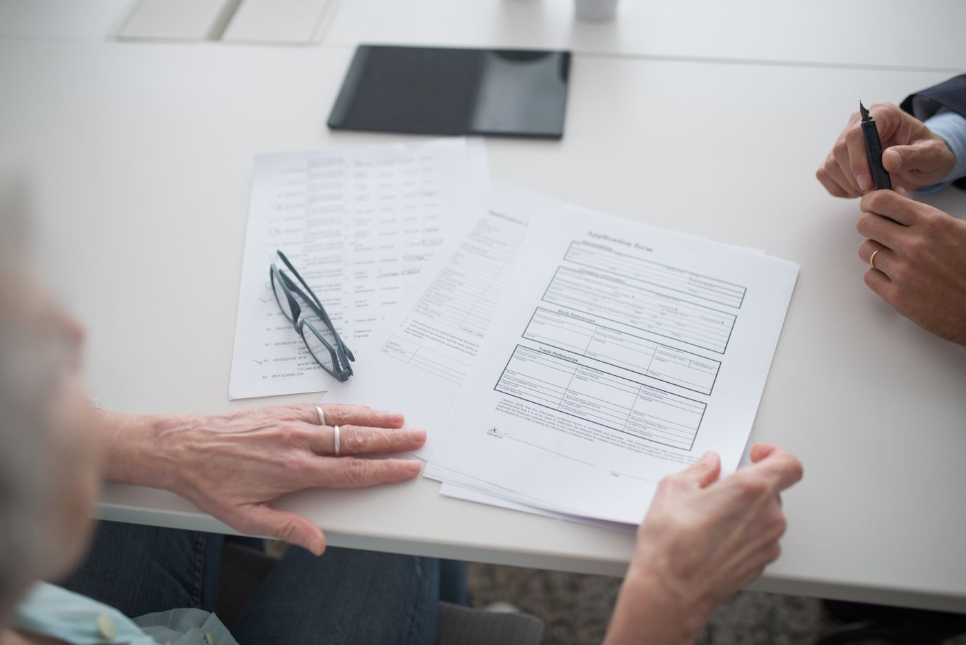 People reviewing documents across a desk