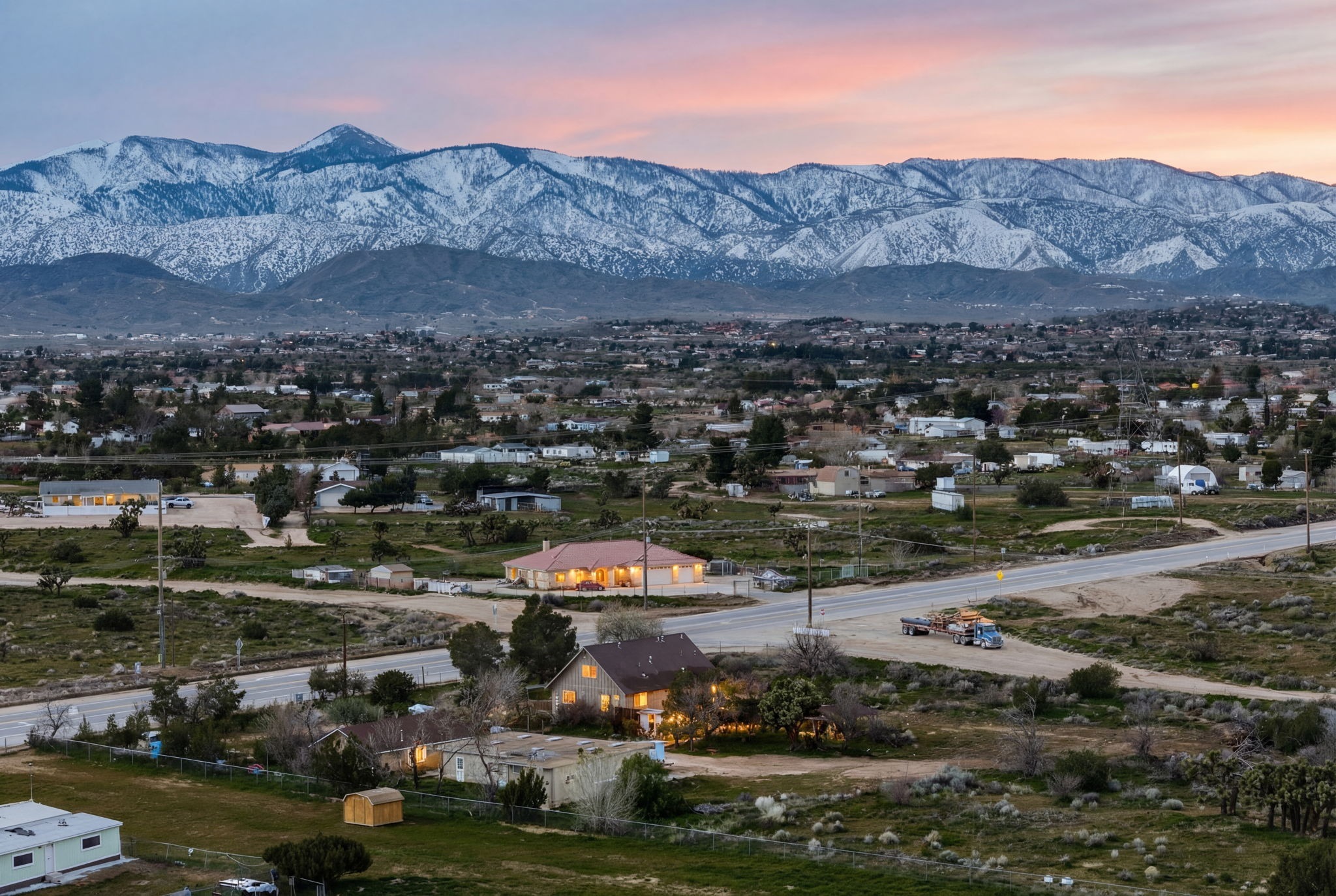 Aerial view of a High Desert probate property with mountains behind