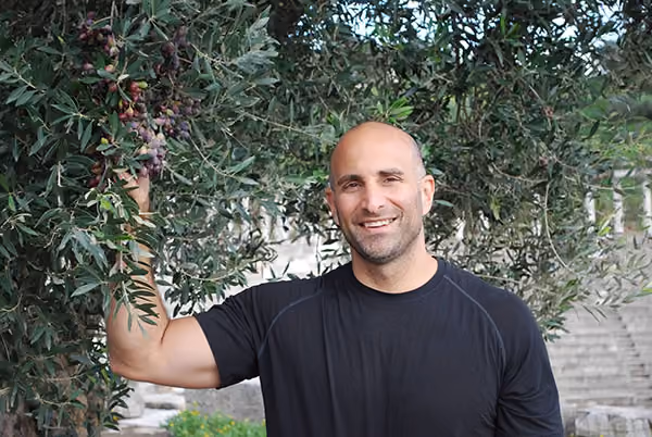 Patient smiling under a tree