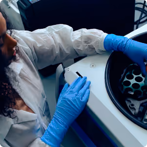 Woman in lab using centrifuge