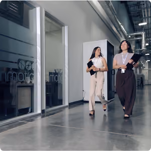 Women walking down office hallway