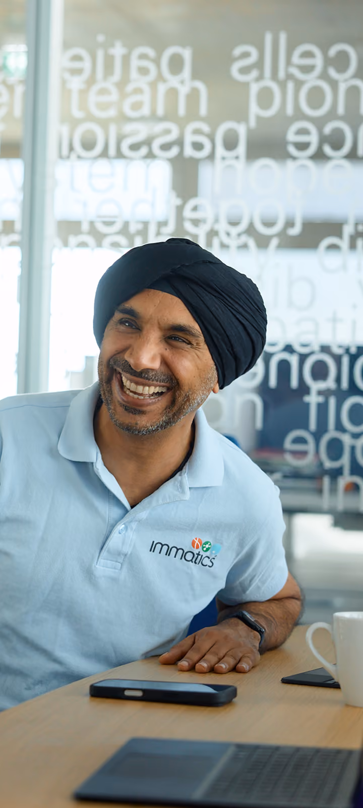 Immatics team member smiling in a conference room