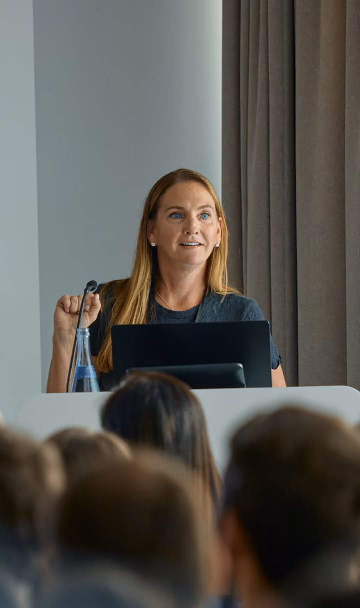 Woman at podium presenting at a press conference