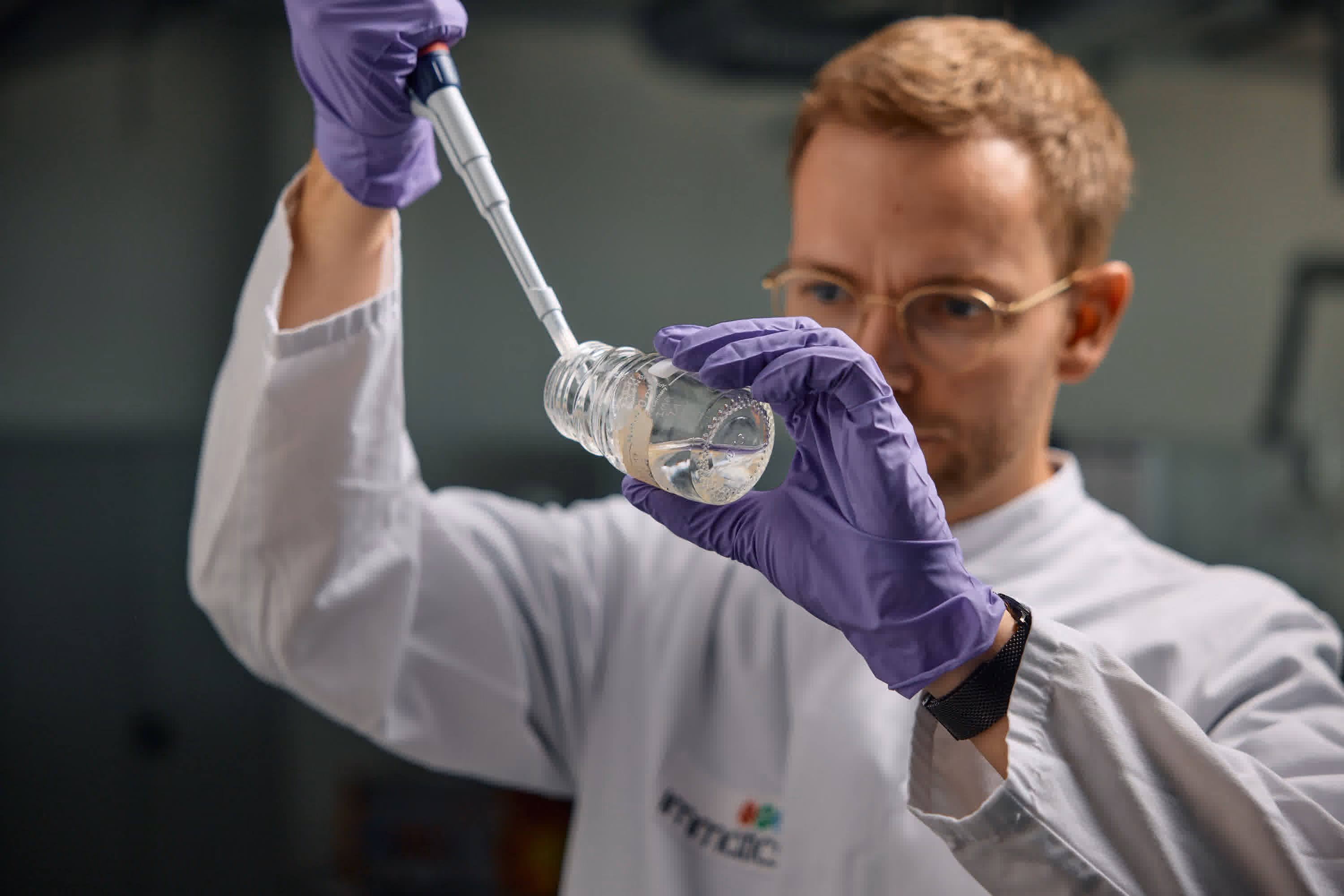 Immatics scientist dispensing from a syringe