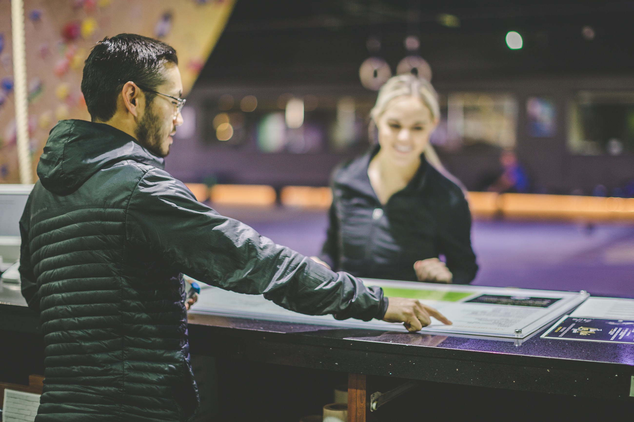 A visitor talking with the BaseCamp front desk team