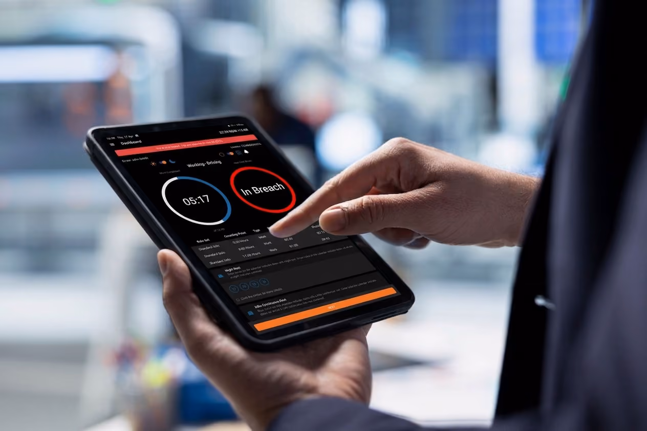 Fleet manager reviewing an electronic work diary on a tablet, showing working time and an in-breach alert