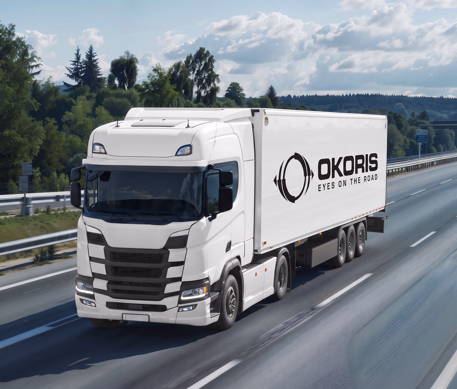 OKORIS-branded prime mover and trailer travelling on a divided highway