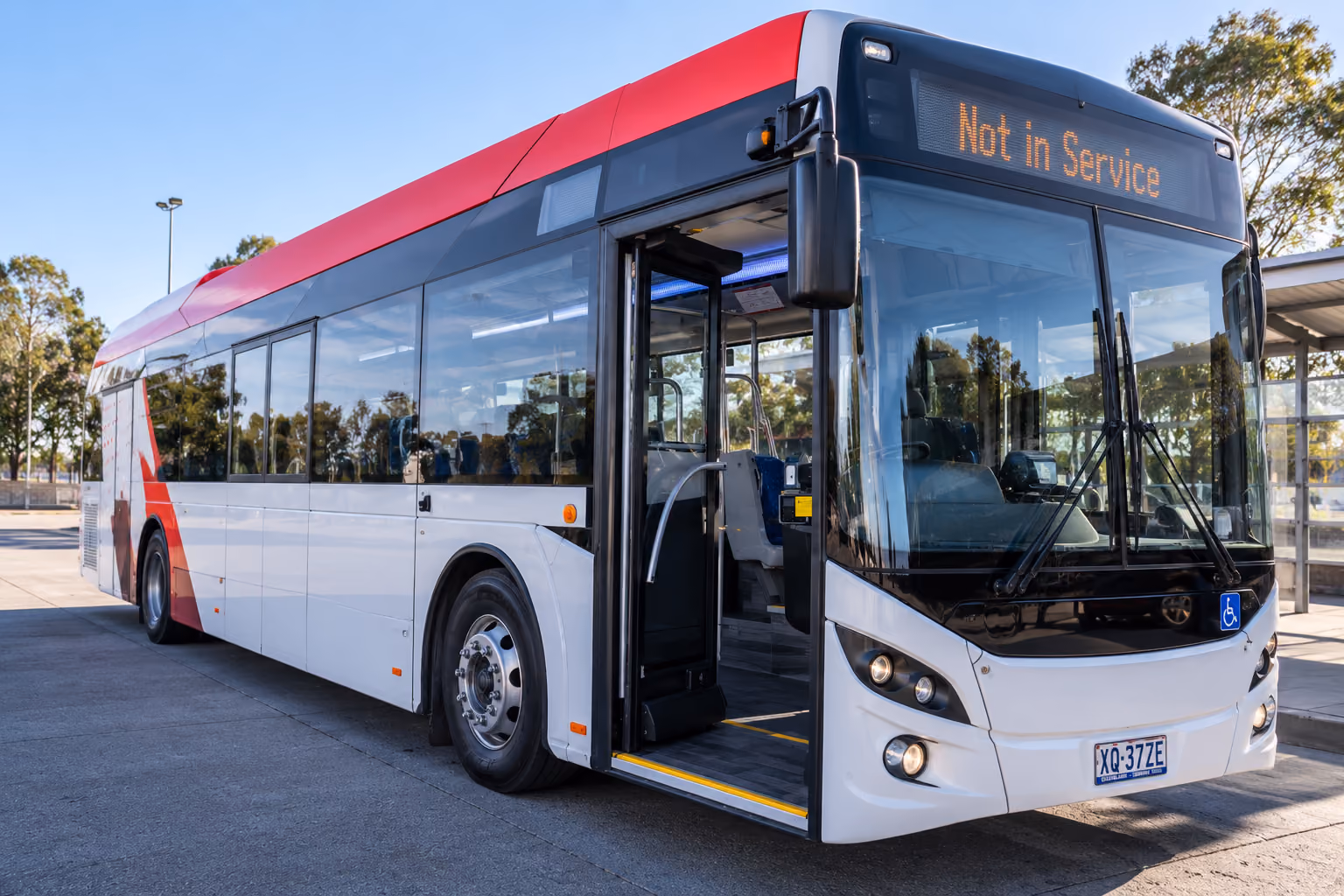 City bus with its door open and boarding ramp deployed at a kerbside stop