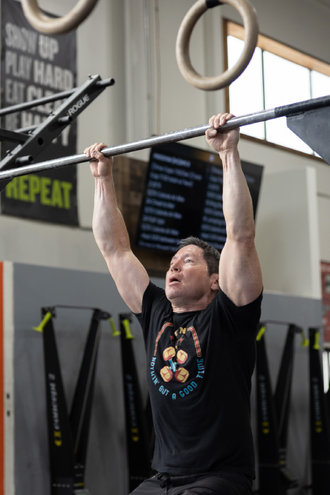 Man performing a pull-up during a CrossFit class at Sundog CrossFit in Fairbanks, Alaska.