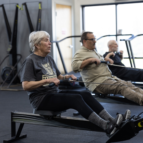 Older adults using rowing machines during a group fitness workout at Sundog CrossFit in Fairbanks, Alaska.