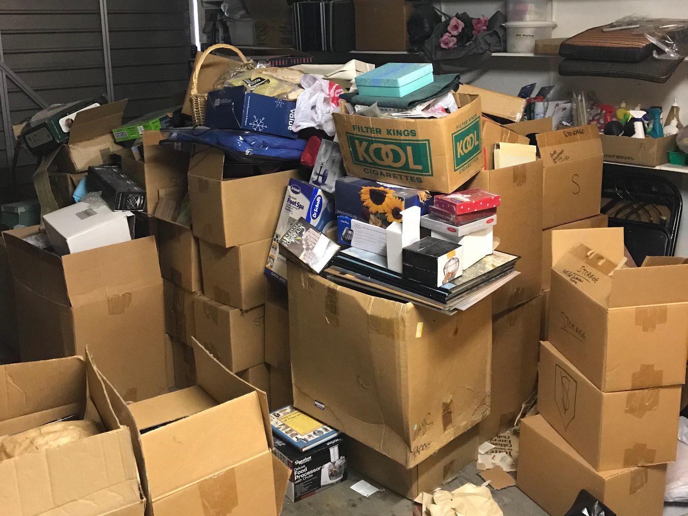 Garage of a Chatsworth probate home before: boxes and belongings stacked to the shelves