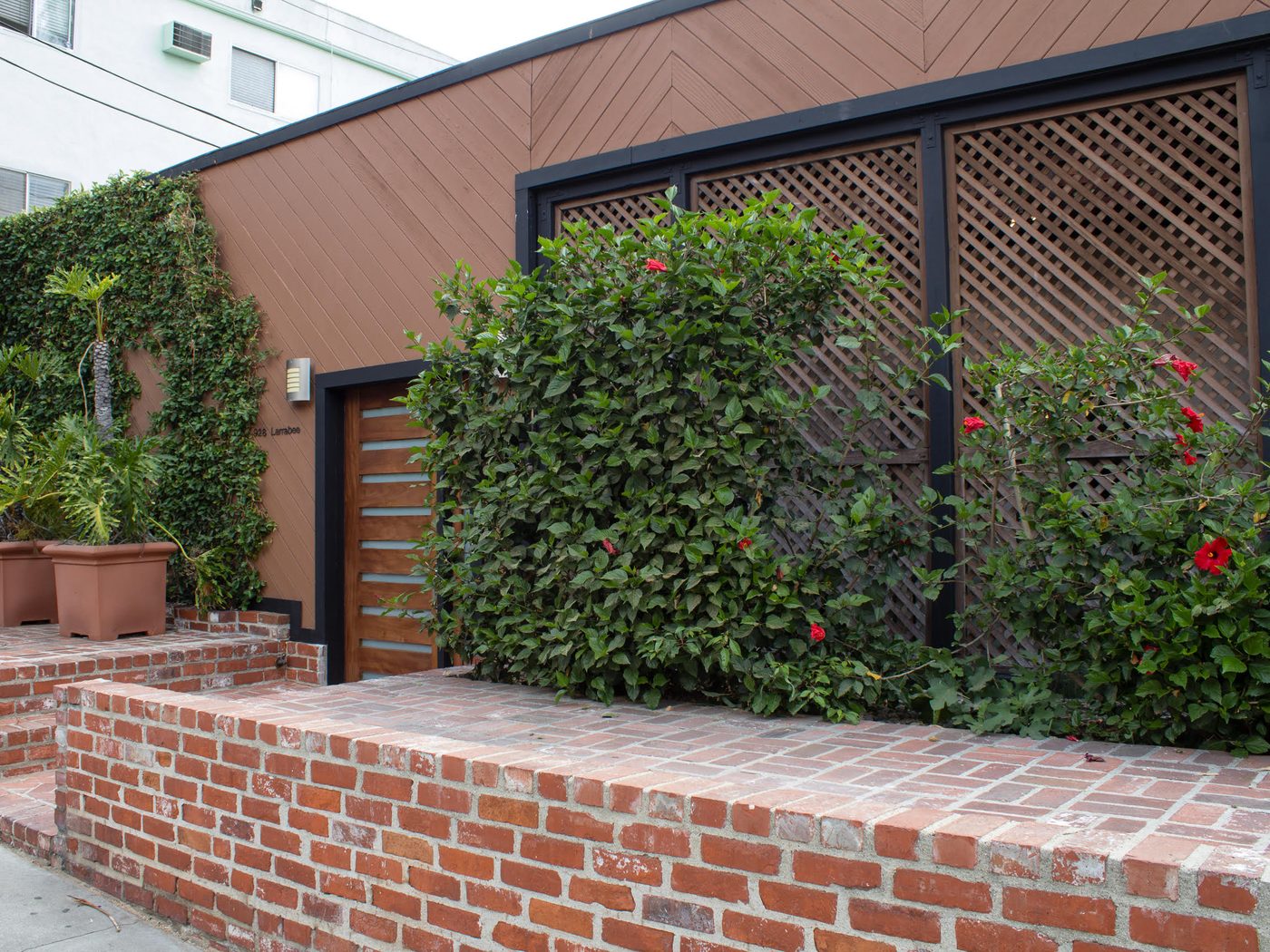 The same West Hollywood street side after the overgrowth was cut back