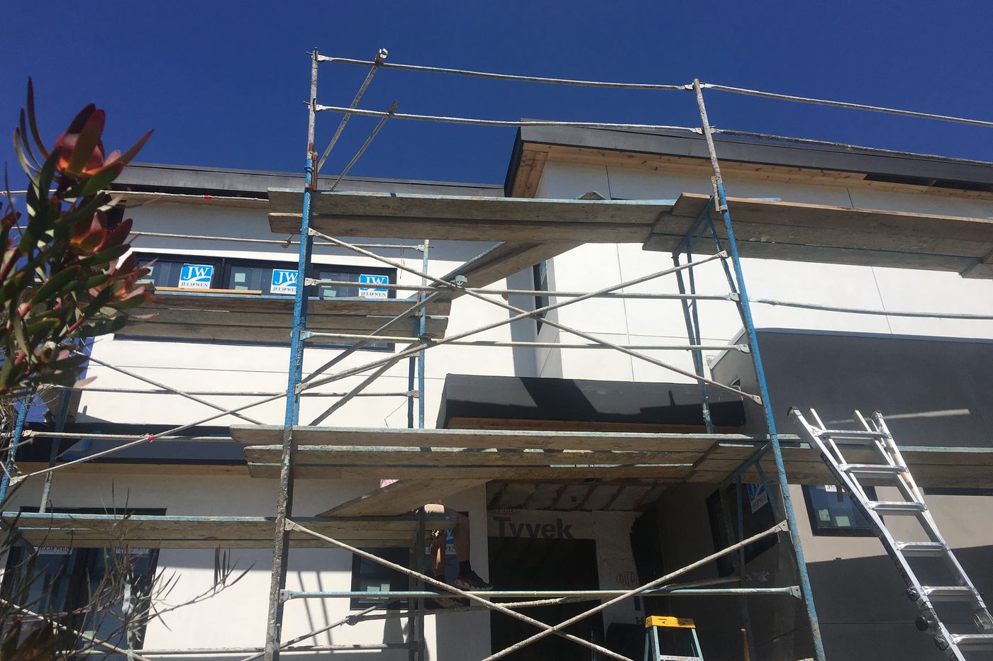 The Modern Monica during construction: scaffolding and house wrap on the back of the house.