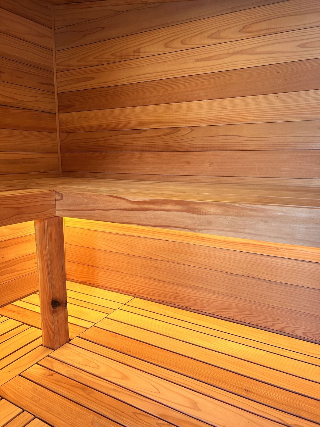 Redwood bench and slatted floor, lit from under the bench