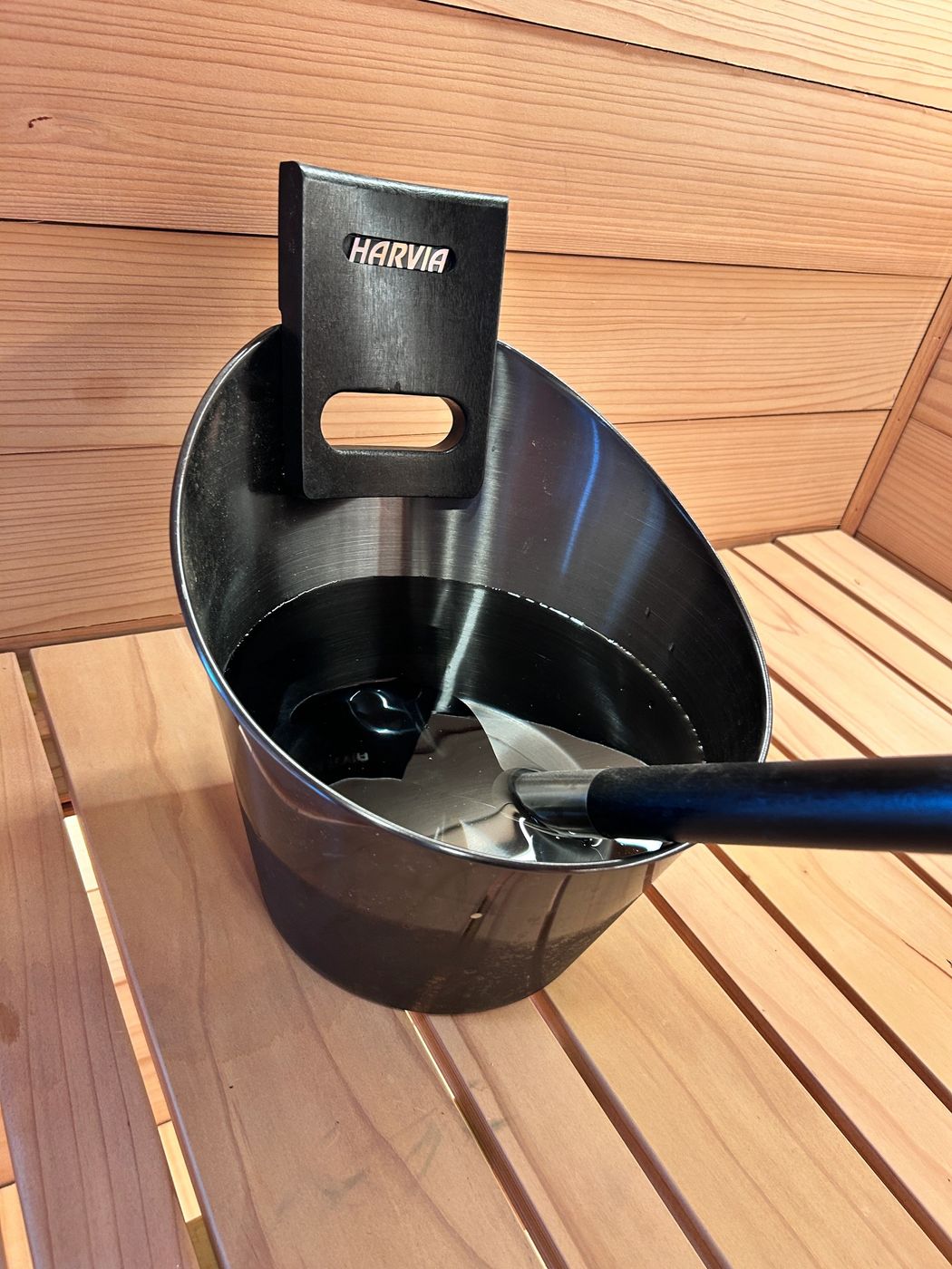Harvia sauna bucket and ladle on the redwood bench