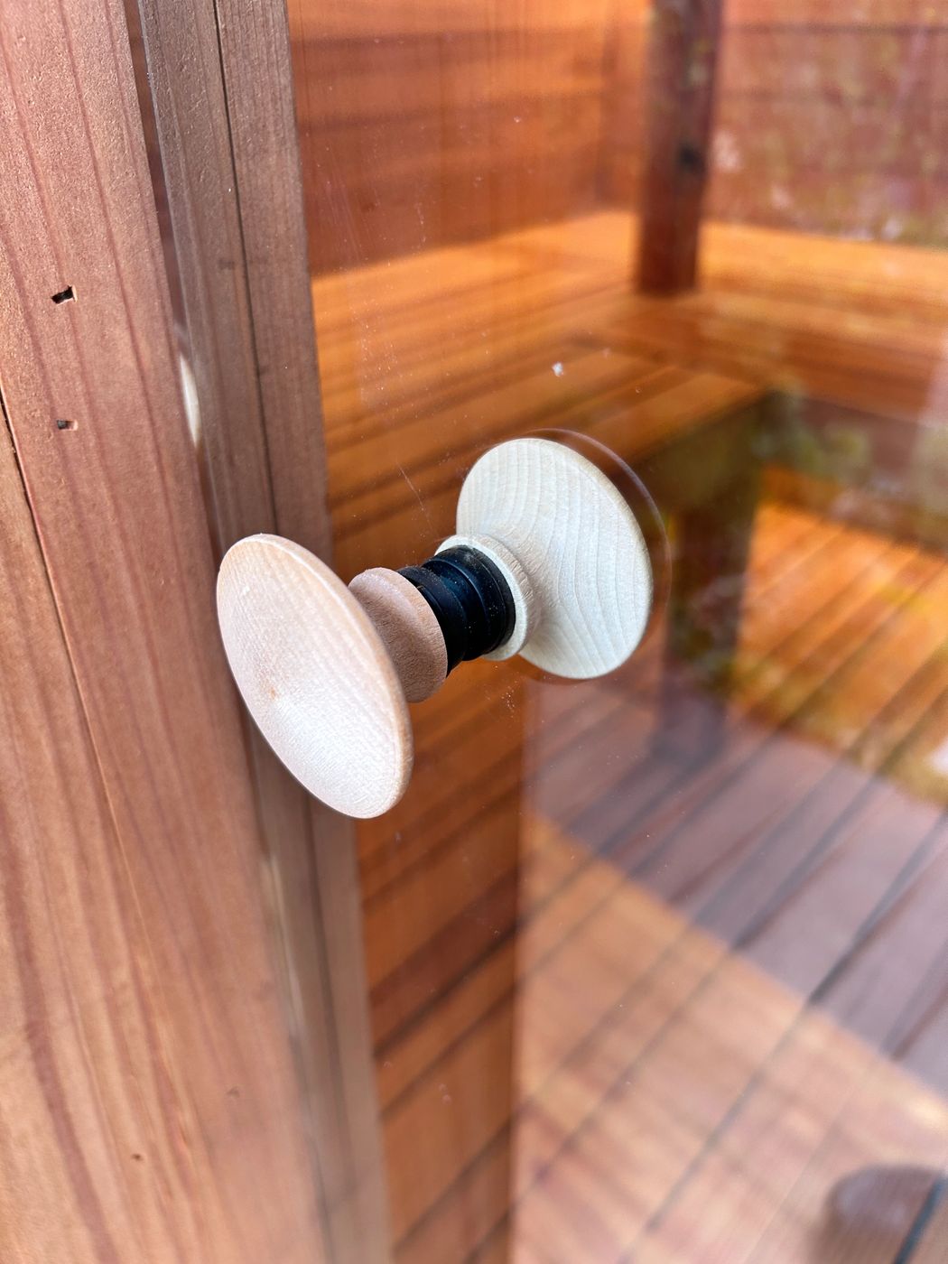 Wooden pull on the sauna's glass door