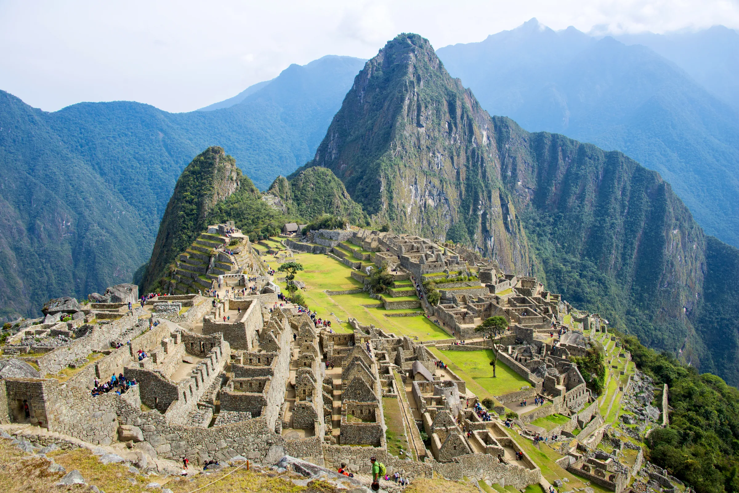 Stone ruins of Machu Picchu beneath mountain peaks