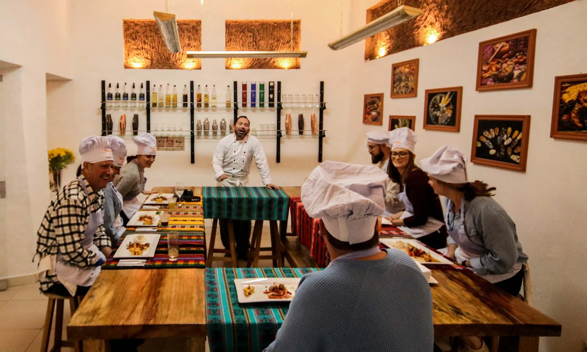 Travelers taking a cooking class with a chef in Peru.