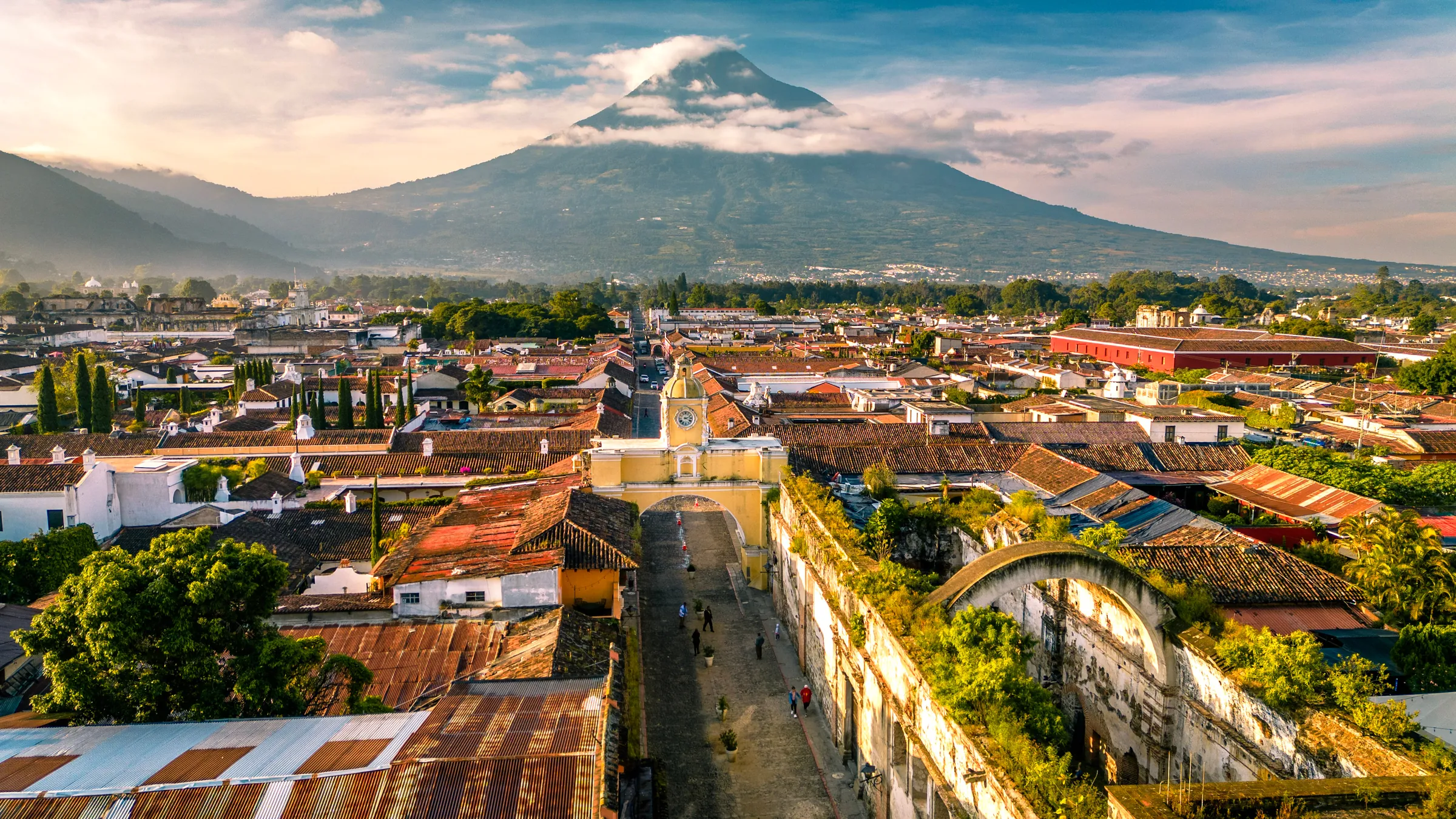 Historic town beneath a broad volcanic peak