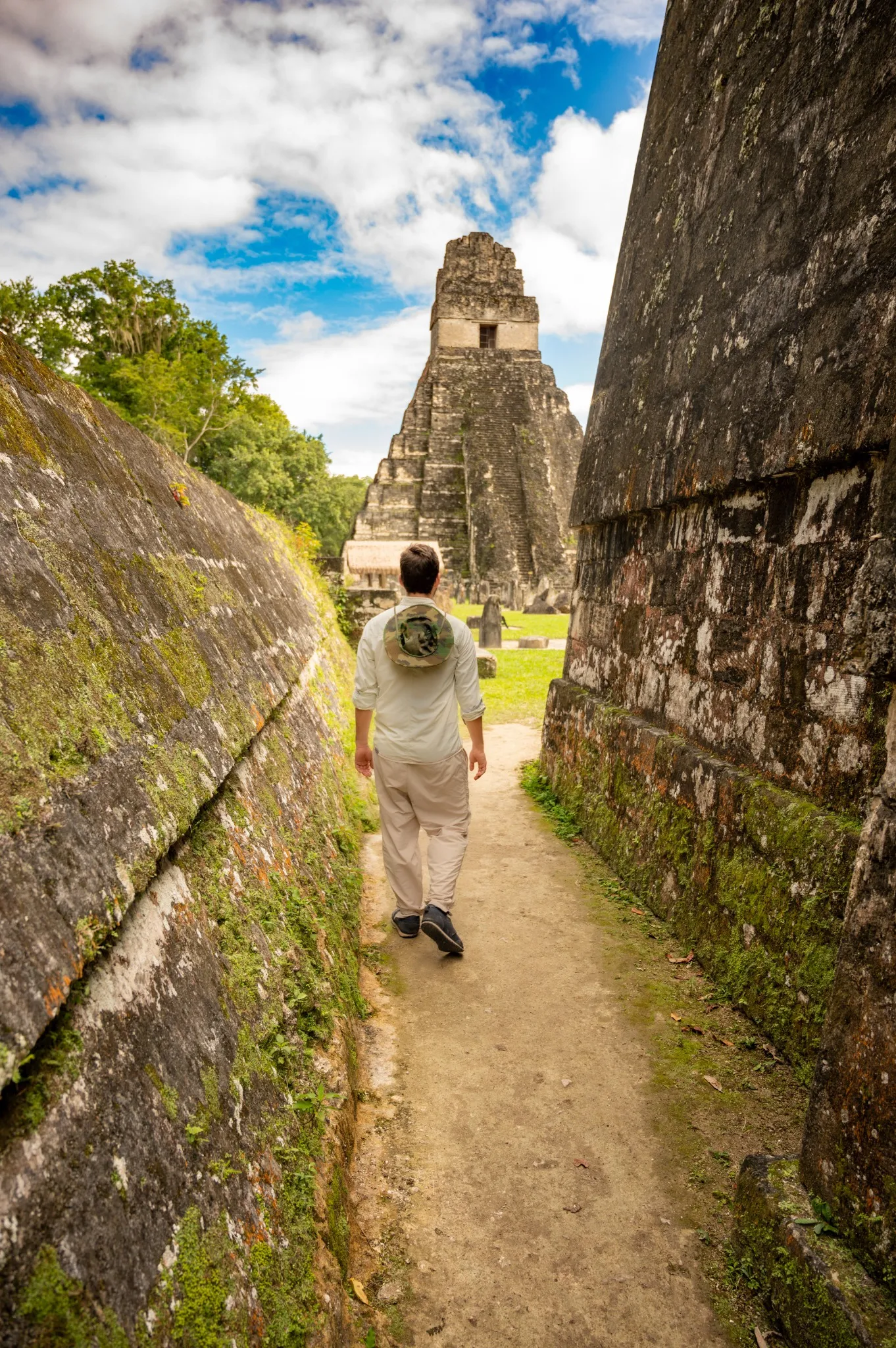 Traveler walking among the Maya temples at Tikal, Guatemala.