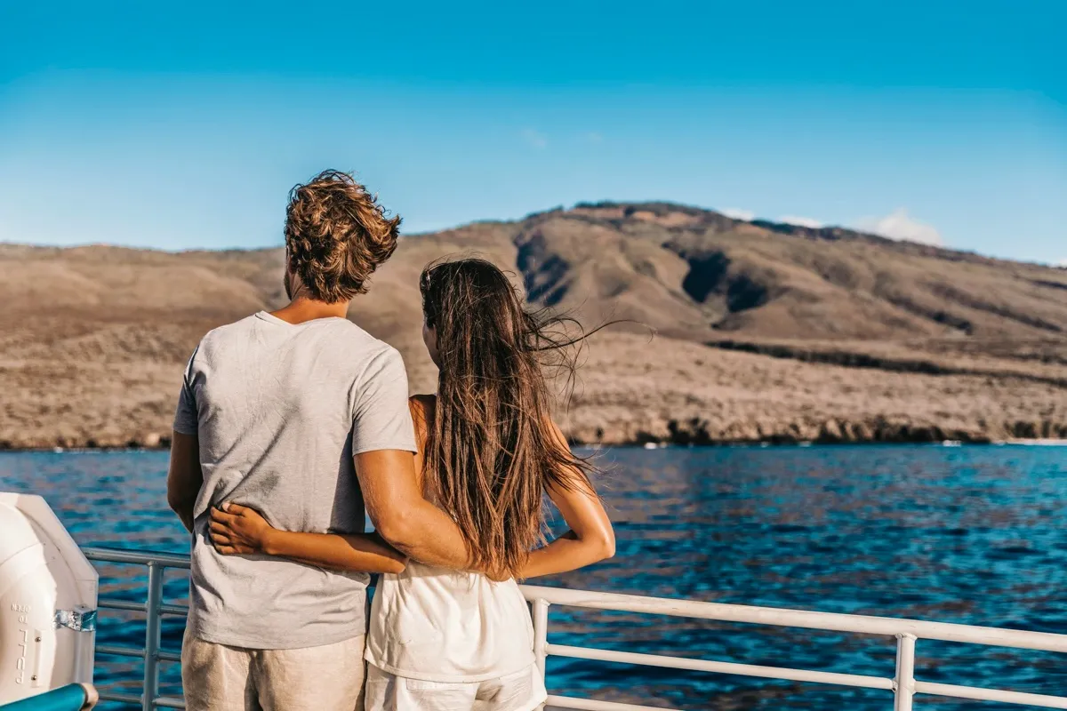 Couple enjoying the view from a yacht deck in the Galapagos Islands.