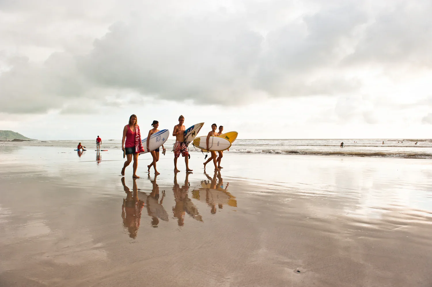 Surfers at Playa Guiones in Nosara, Costa Rica