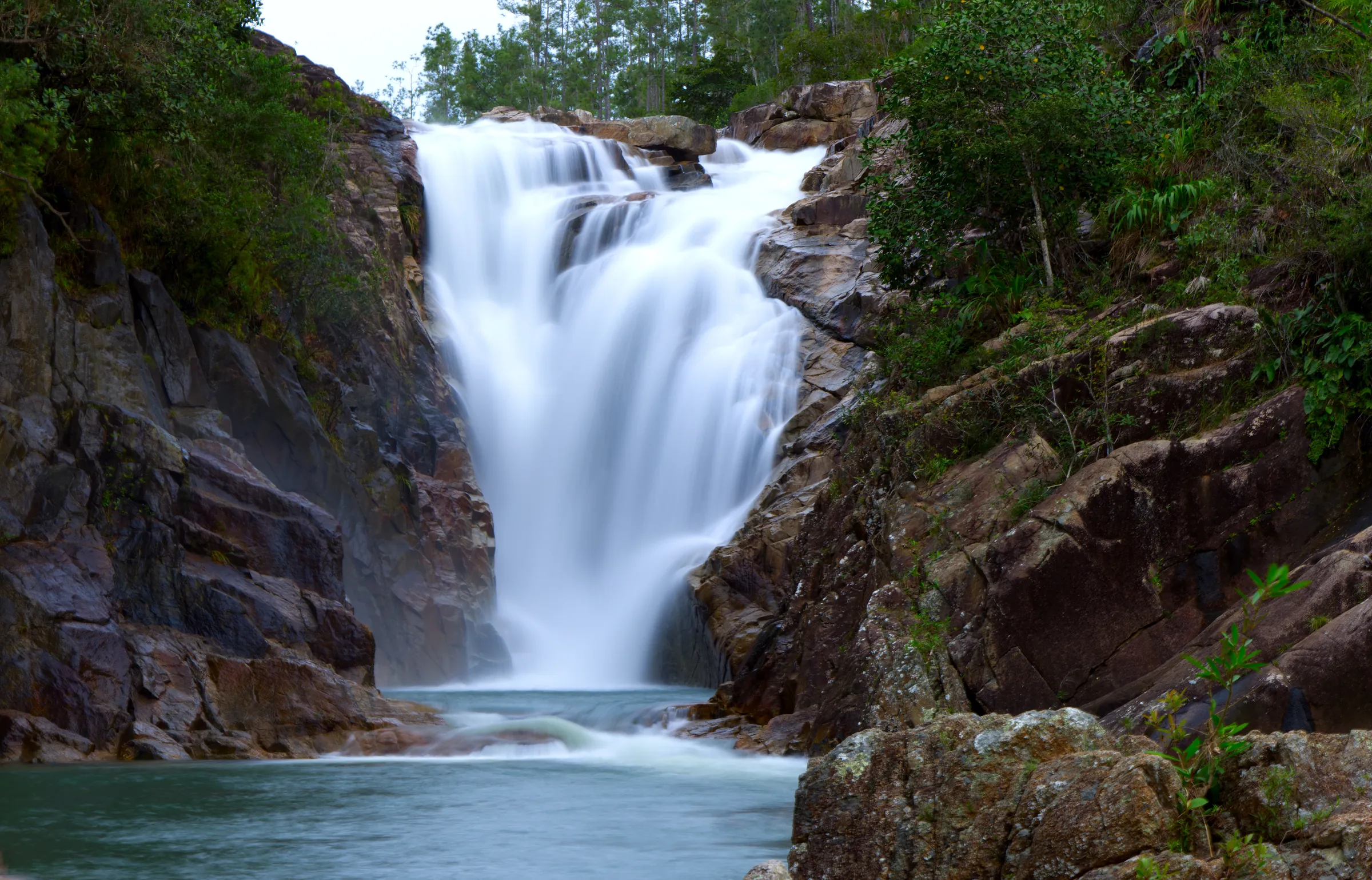 Waterfall cascading into a pool between rocks