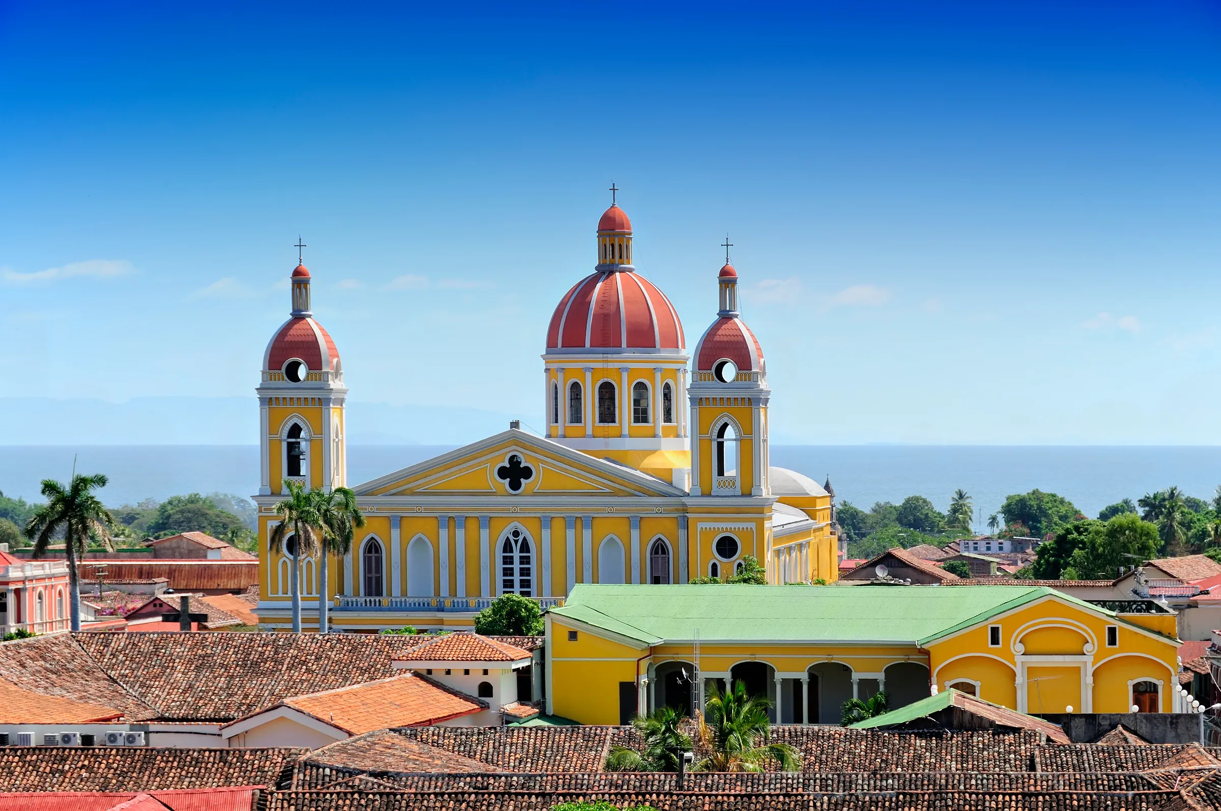 Yellow cathedral with red domes above Granada