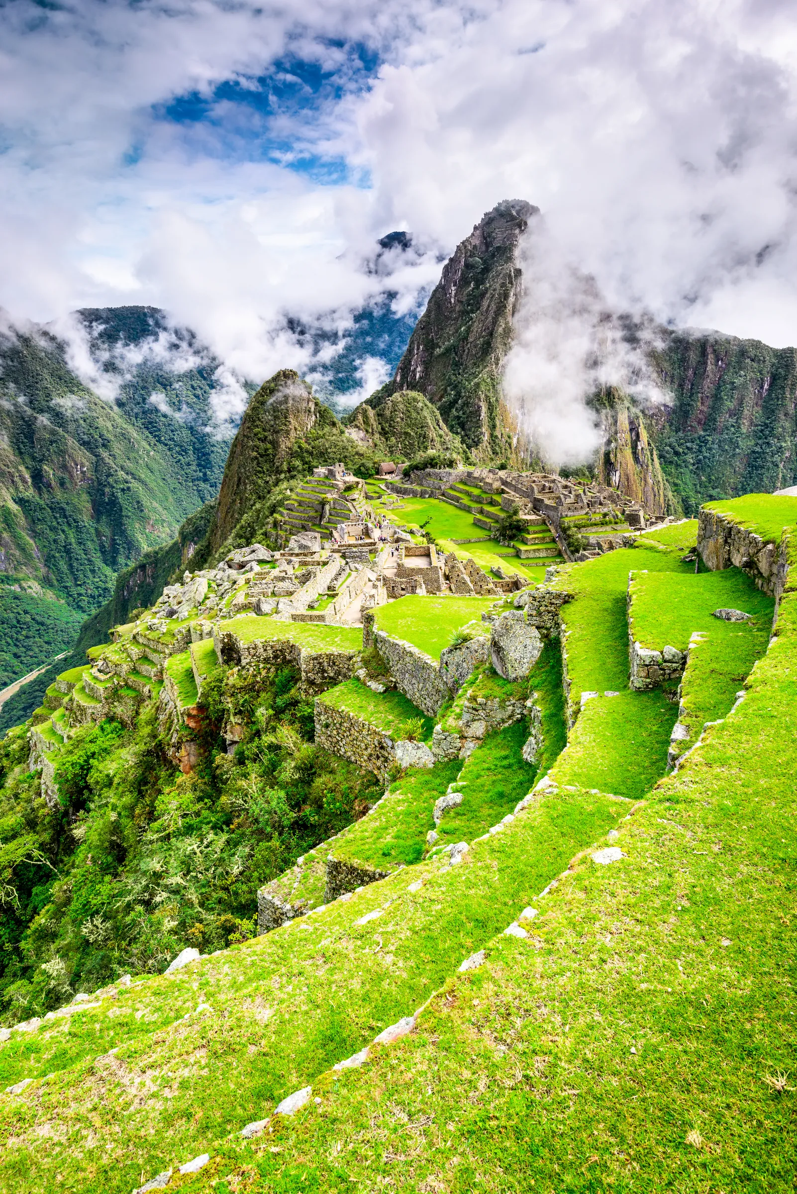 Green Inca terraces below steep mountain peaks