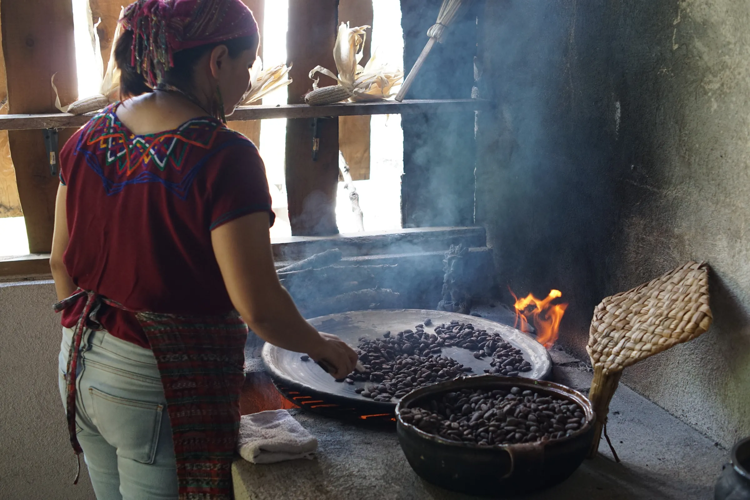 Cook preparing food on a wood-fired stove