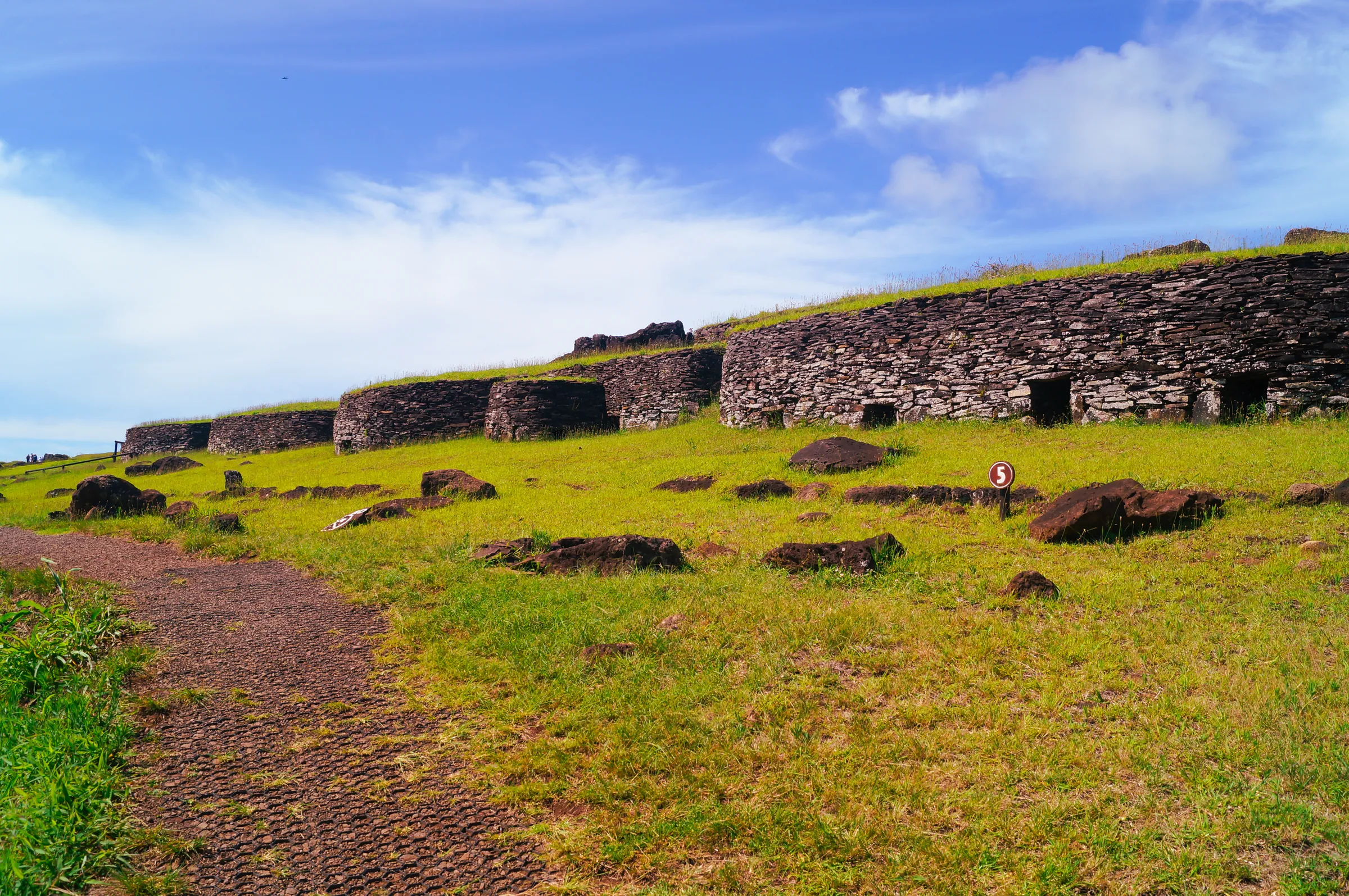 Ancient stone foundations across a grassy slope