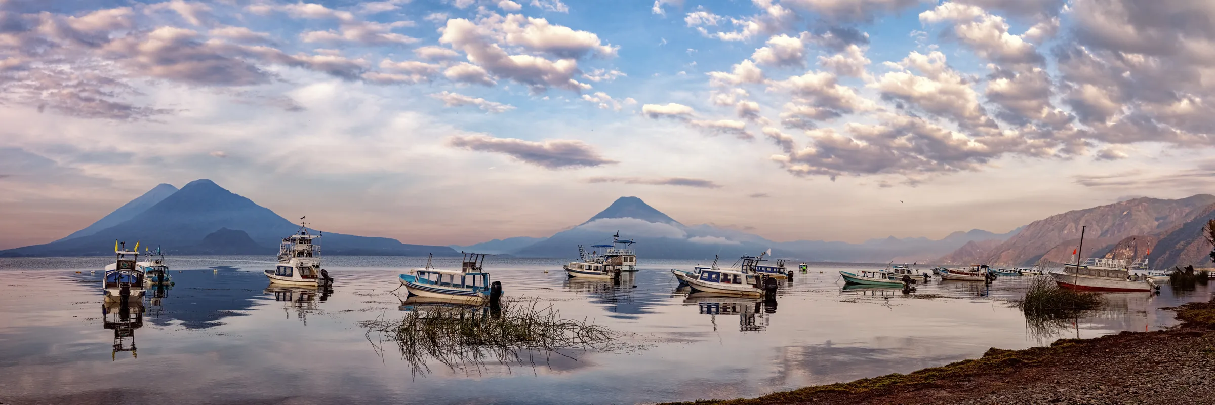 Boats on Lake Atitlán at sunrise