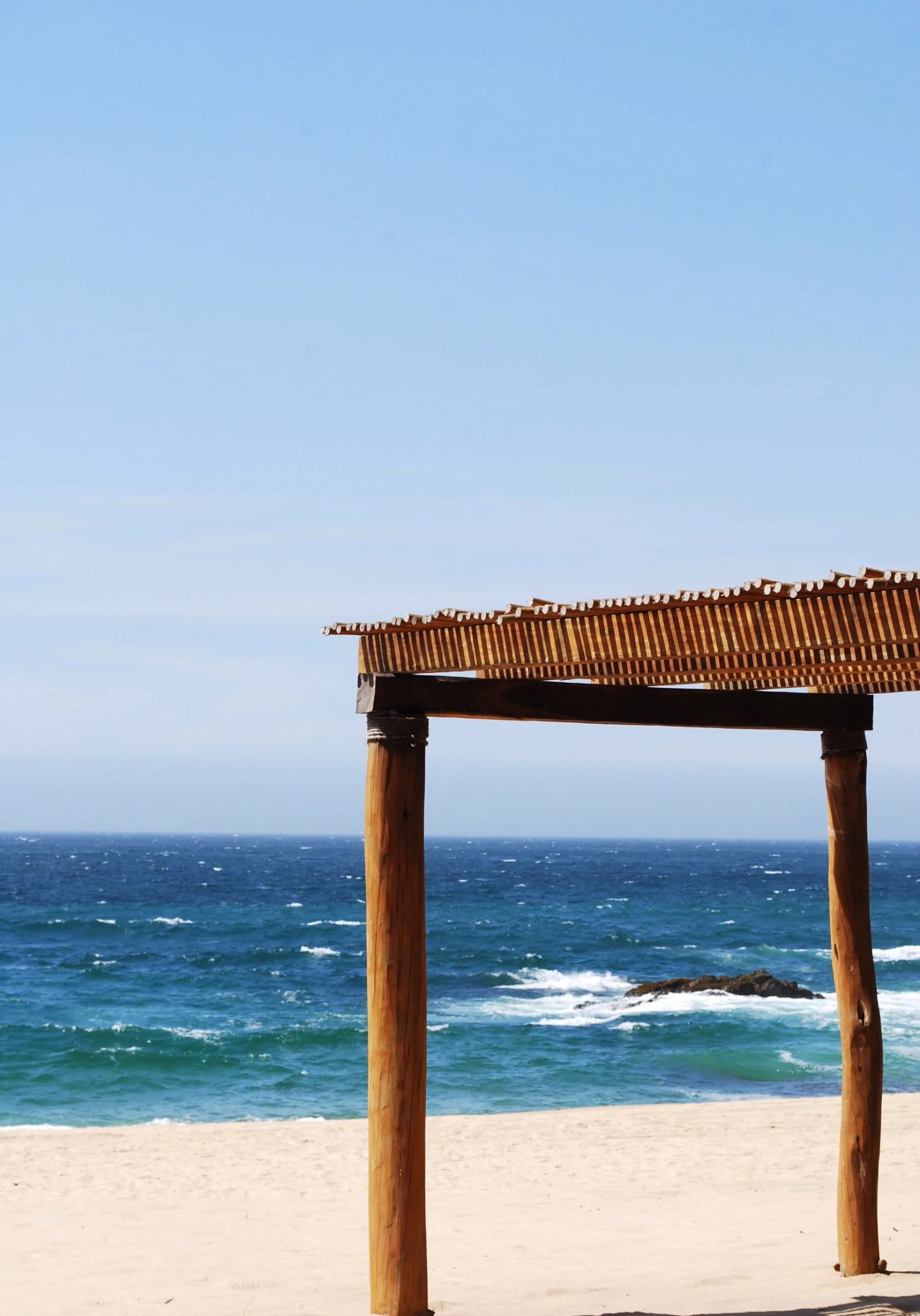 Rustic wooden beach pergola facing the deep blue Pacific on the Costalegre