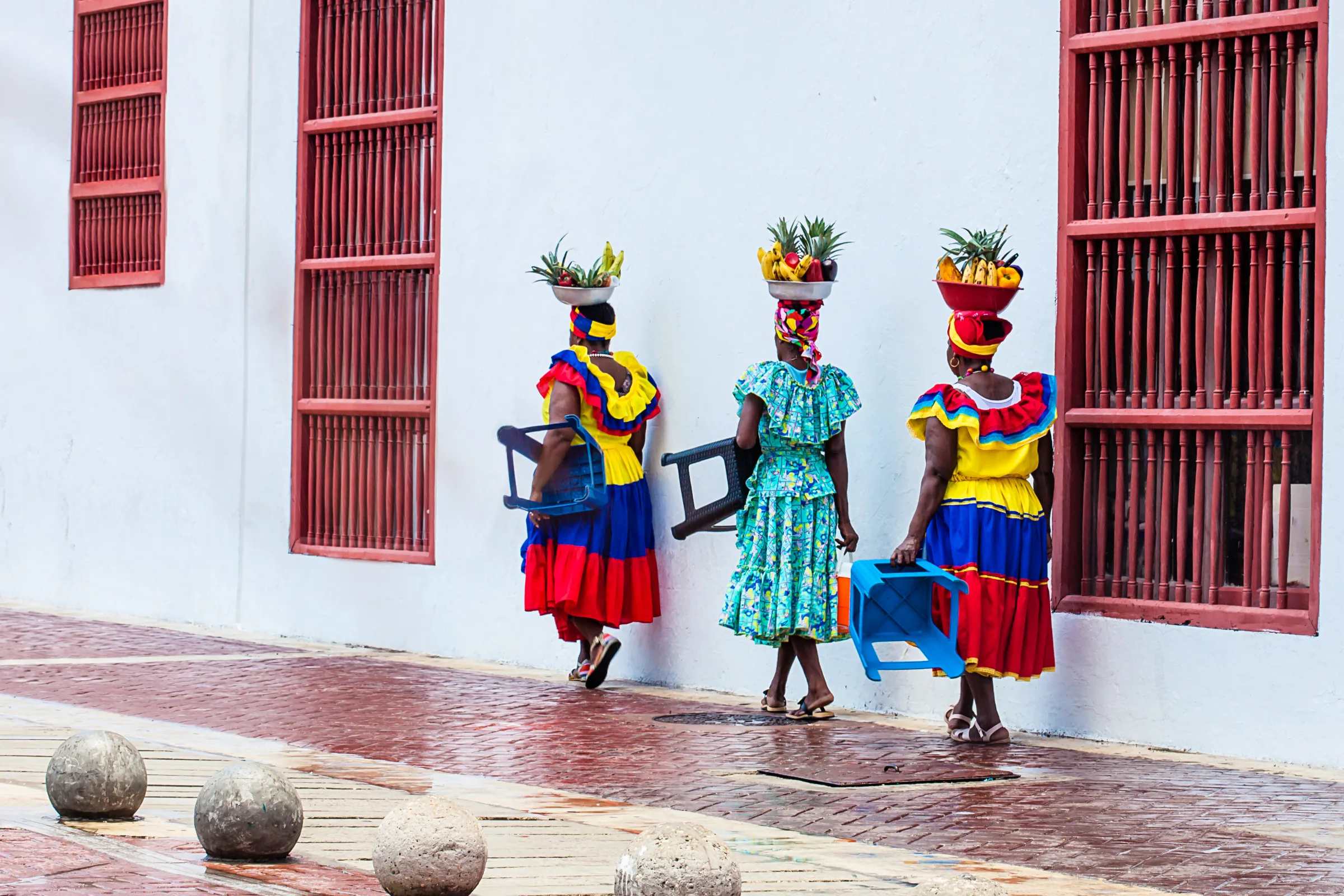Palenquera fruit vendors walking through the old city of Cartagena, Colombia