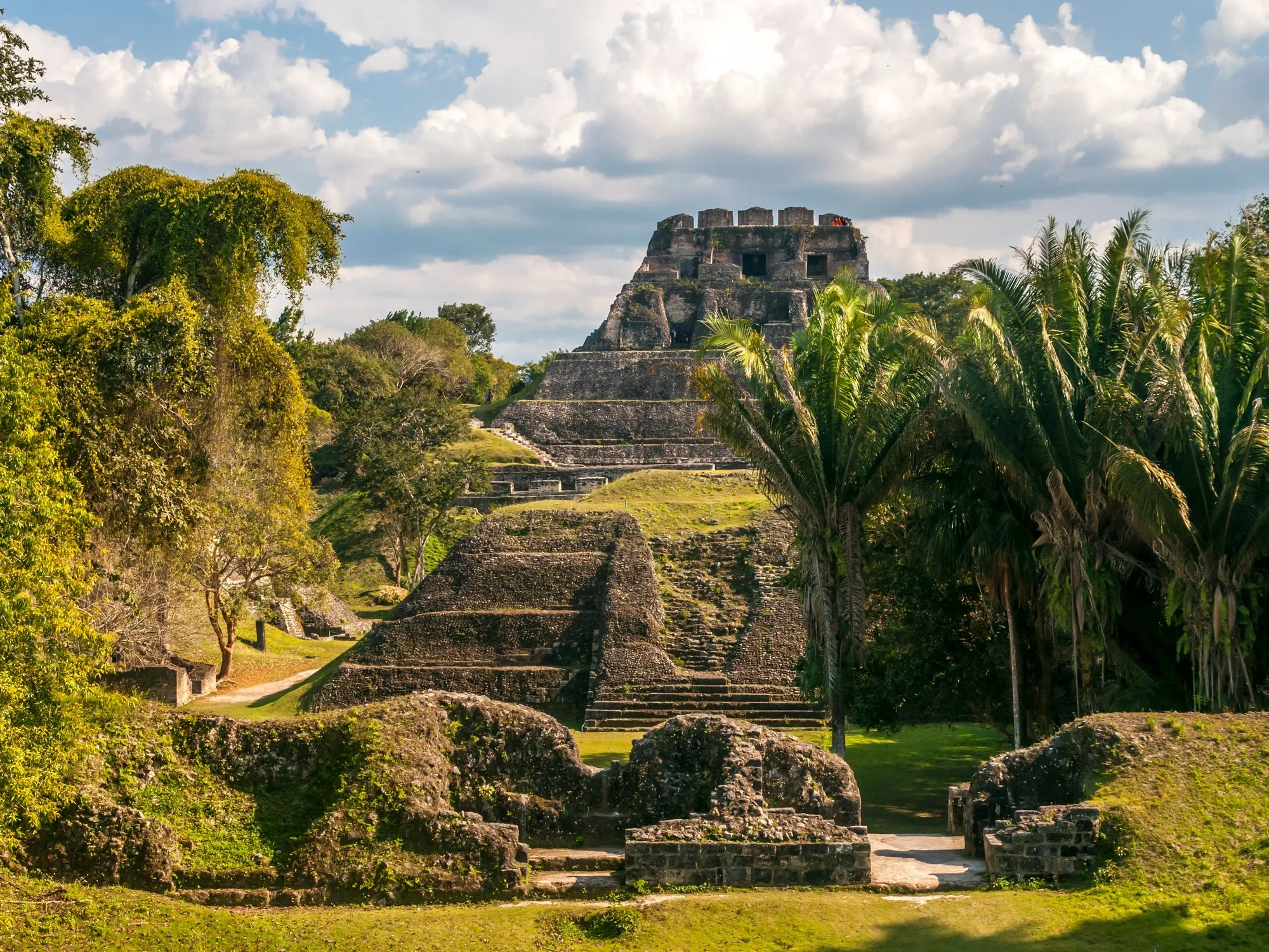 A close-up view of the ancient Maya temple at Xunantunich framed by jungle foliage. Cayo, Belize.