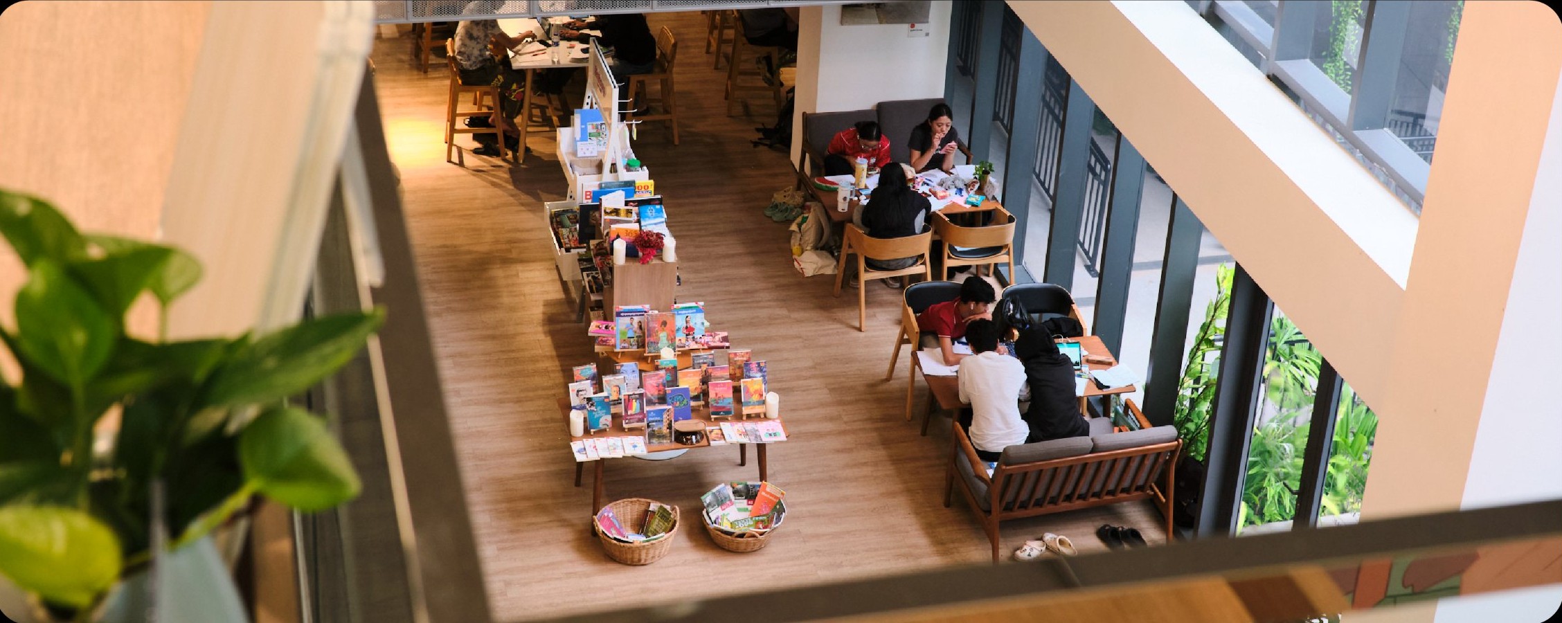 A long shared table on the coworking floor, seen from above