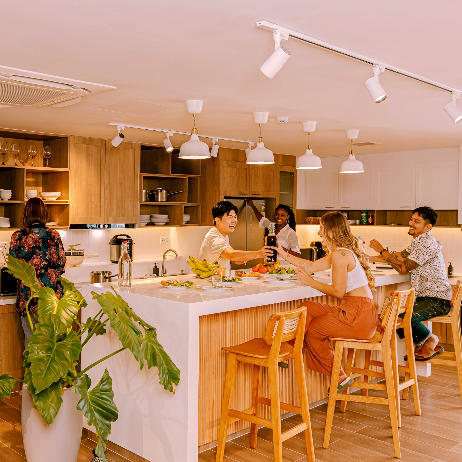 Housemates sharing a meal around the kitchen island
