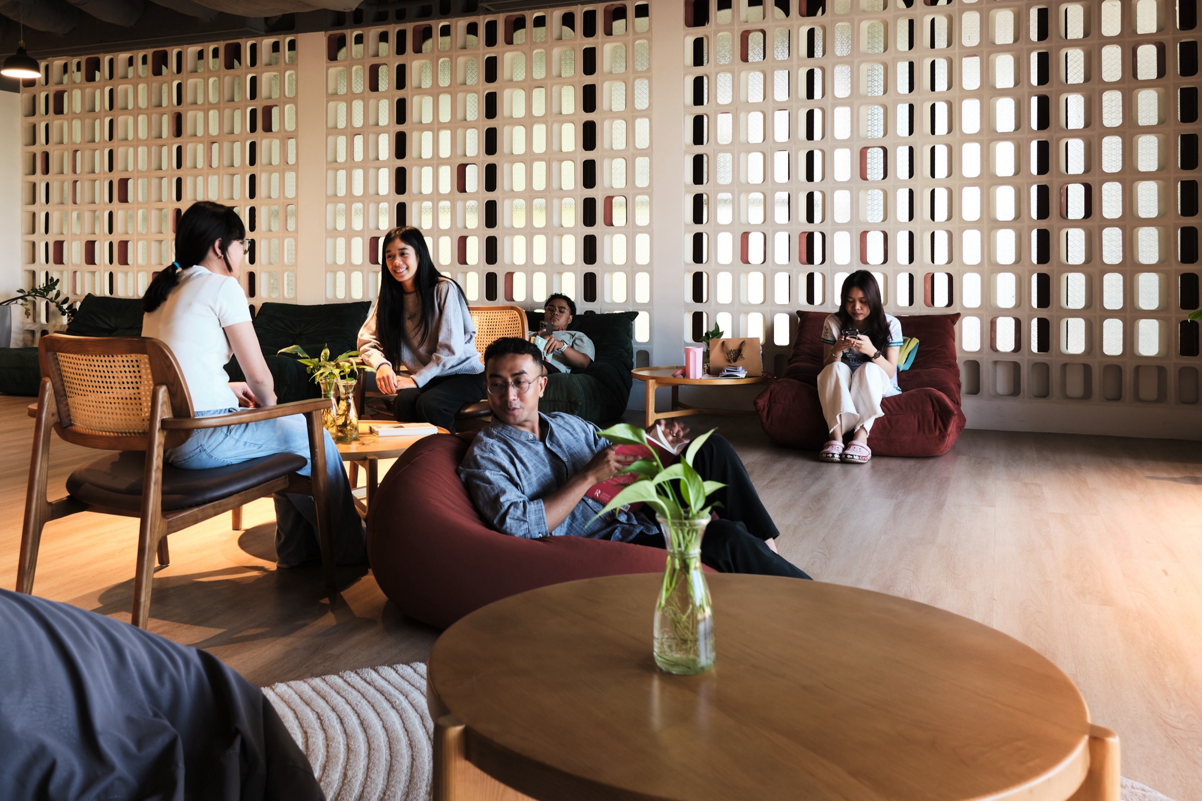 Housemates talking in the Commune lounge