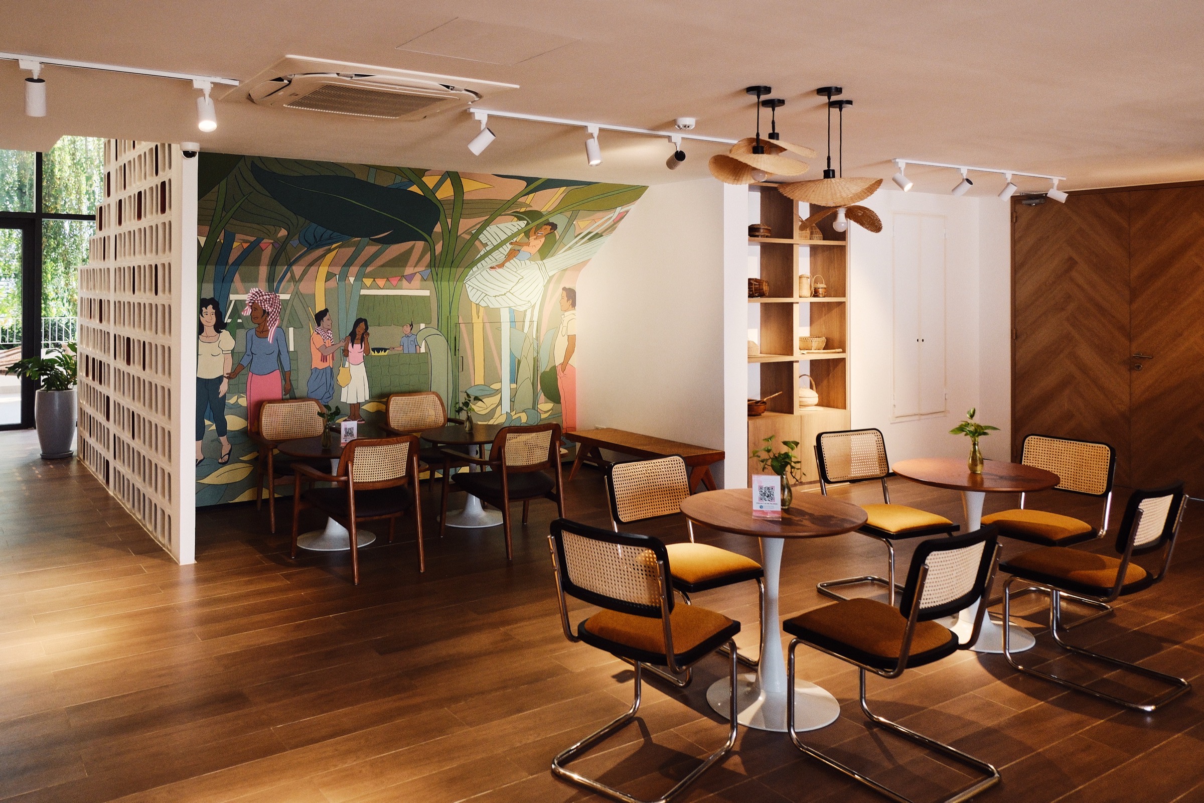 The mural room set with tables for a gathering