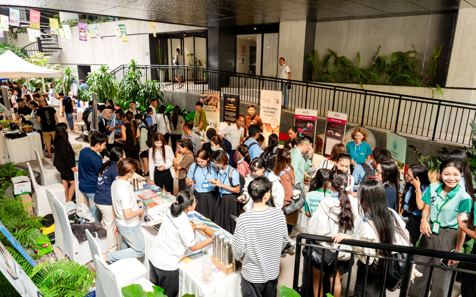 A community market and networking event in the Commune atrium, stalls and visitors