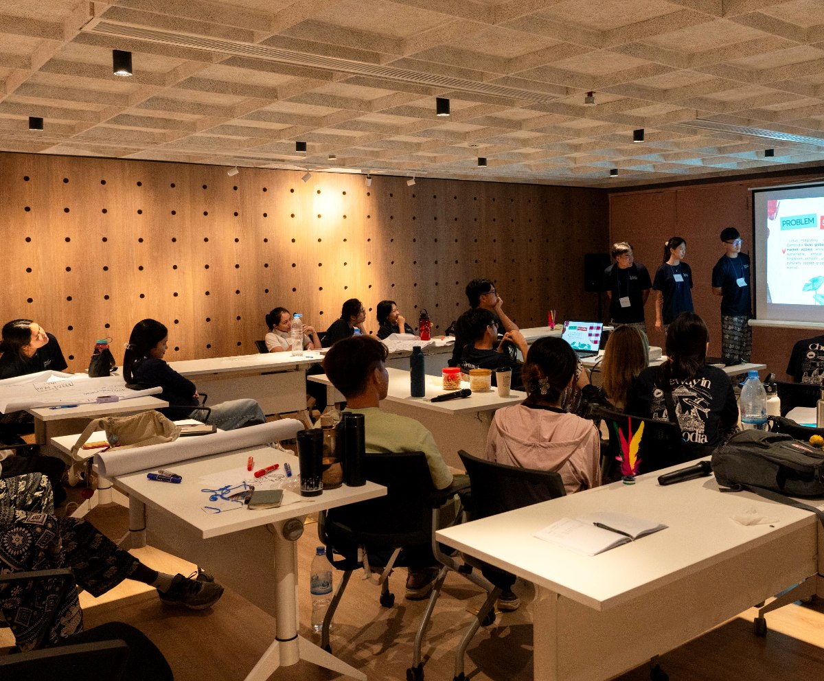 A workshop in progress at Commune, participants at clustered tables